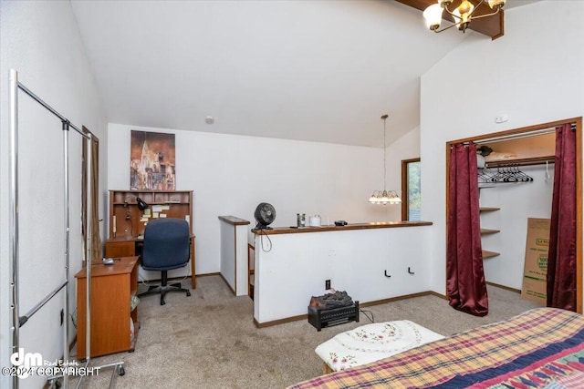 bedroom with an inviting chandelier, vaulted ceiling, a closet, and light carpet