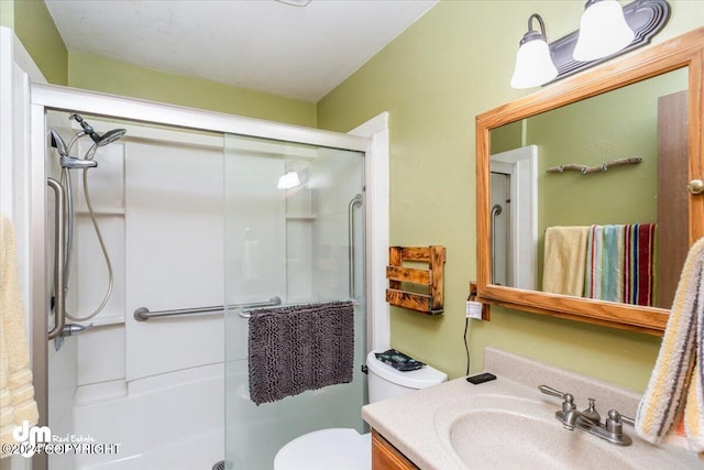 bathroom with walk in shower, vanity, and toilet