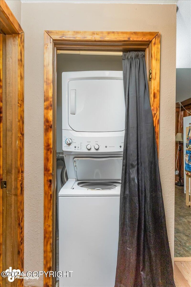 laundry area with stacked washer / drying machine