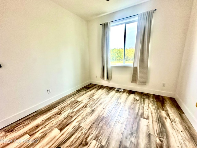 empty room with hardwood / wood-style flooring