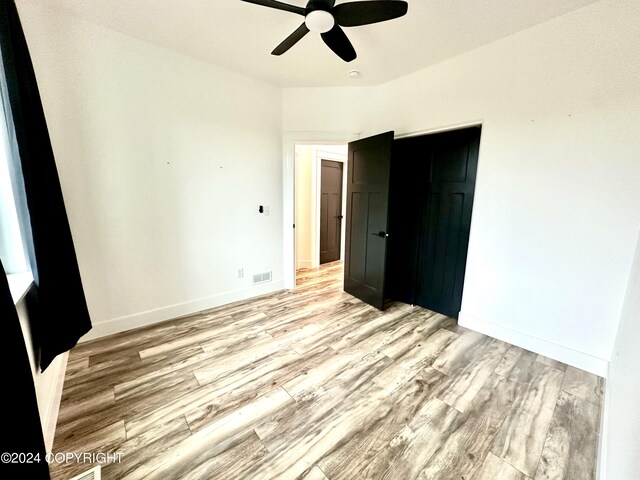 unfurnished bedroom with light hardwood / wood-style flooring and ceiling fan