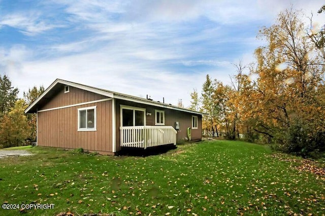 view of side of home with a yard