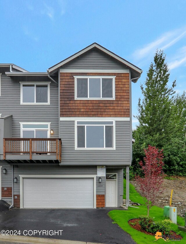 view of front of property featuring a balcony and a garage