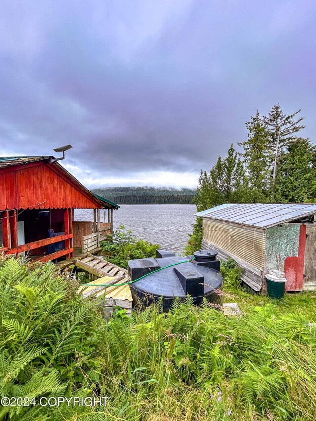 view of yard featuring a water view and an outdoor structure