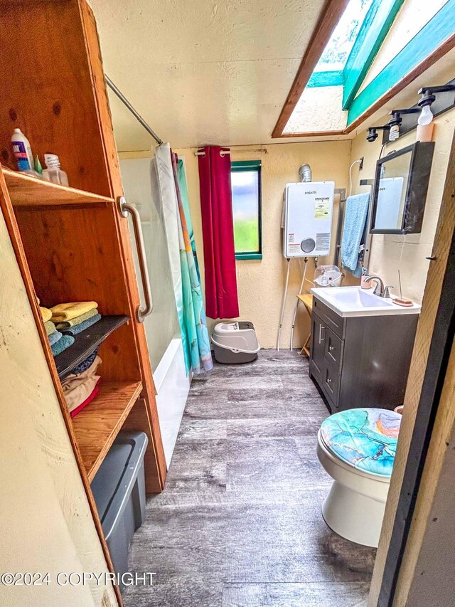 full bathroom featuring toilet, water heater, vanity, shower / tub combo with curtain, and hardwood / wood-style flooring