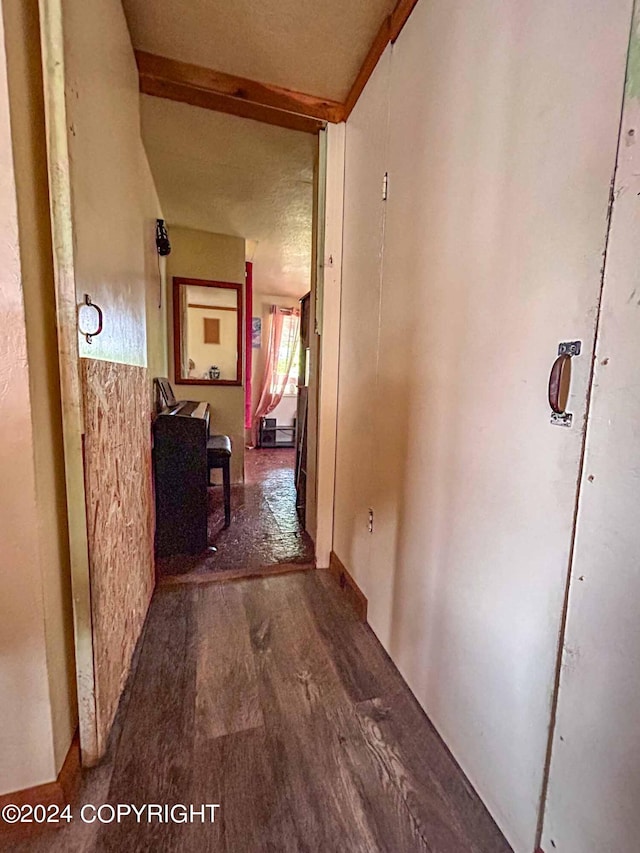 hallway featuring a textured ceiling and dark wood-type flooring