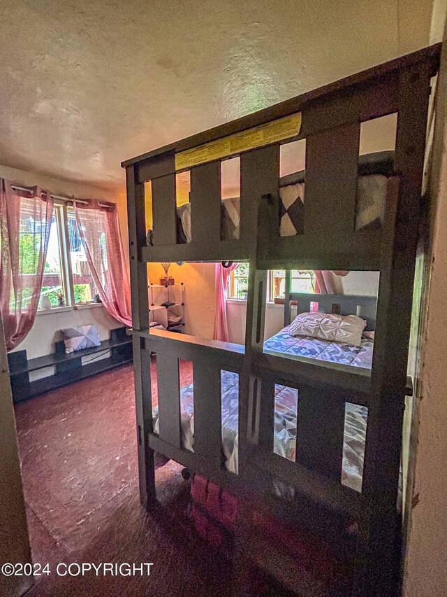 bedroom with multiple windows and a textured ceiling