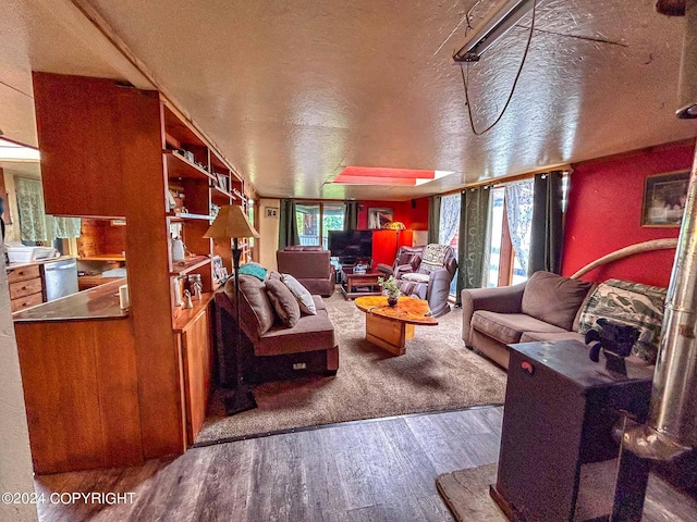 living room with a textured ceiling, a wealth of natural light, and hardwood / wood-style floors