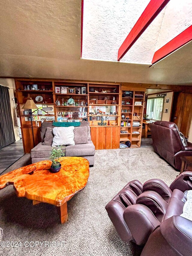 living room with a textured ceiling and carpet