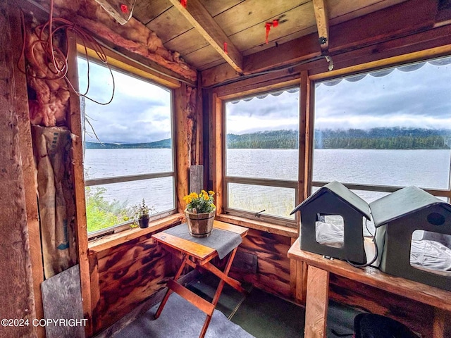 sunroom / solarium with wooden ceiling, a water view, and a wealth of natural light