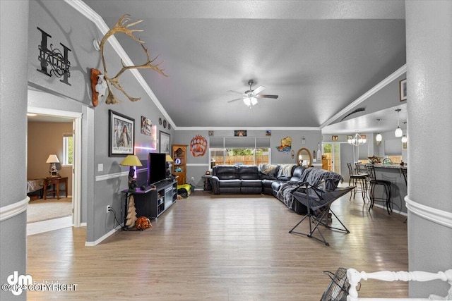 living room with lofted ceiling, ceiling fan, hardwood / wood-style flooring, and crown molding