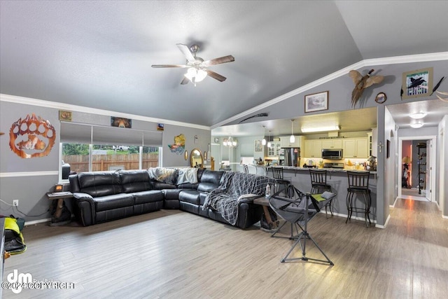 living room featuring crown molding, vaulted ceiling, hardwood / wood-style flooring, and ceiling fan