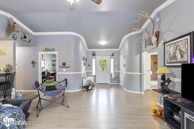 interior space featuring crown molding, ceiling fan, and light hardwood / wood-style floors