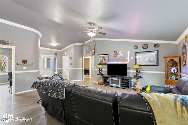 living room with crown molding, vaulted ceiling, hardwood / wood-style flooring, and ceiling fan