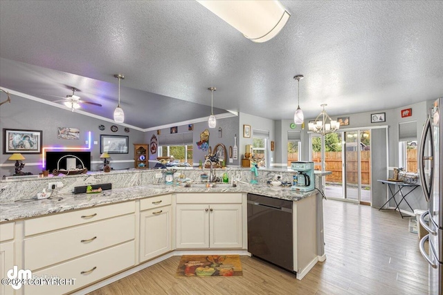 kitchen with light hardwood / wood-style flooring, vaulted ceiling, ceiling fan with notable chandelier, and appliances with stainless steel finishes