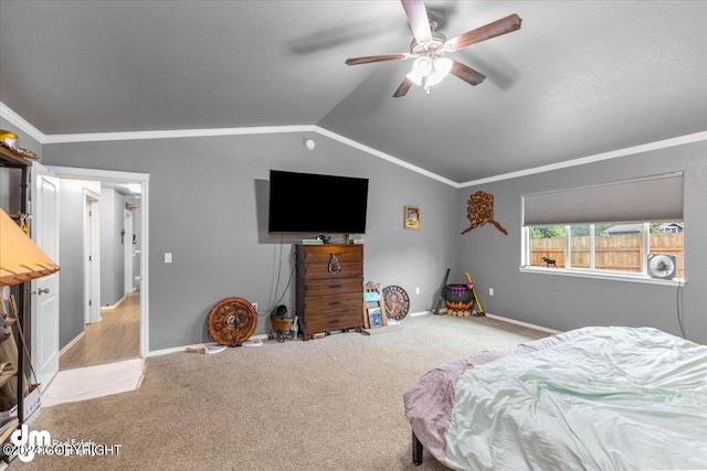 bedroom featuring crown molding, vaulted ceiling, light colored carpet, and ceiling fan