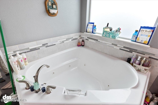 bathroom featuring a bath and a wealth of natural light