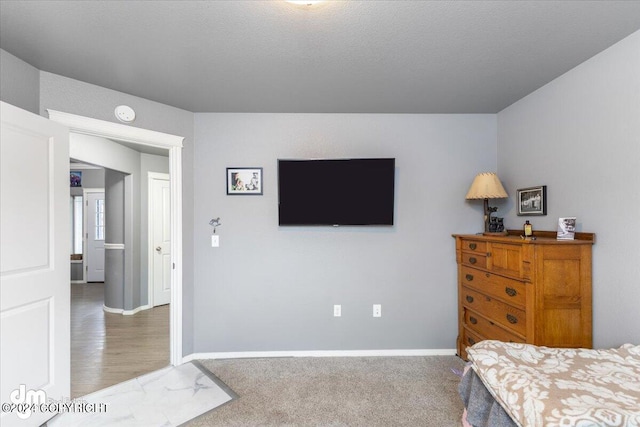 carpeted bedroom with a textured ceiling