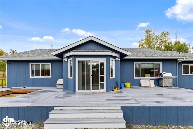 rear view of house featuring a deck