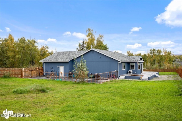 back of house featuring a patio area and a yard