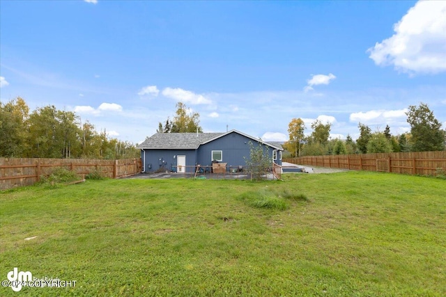 back of house featuring a yard and a patio area