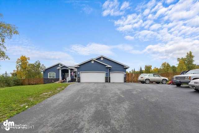 single story home with a garage and a front yard