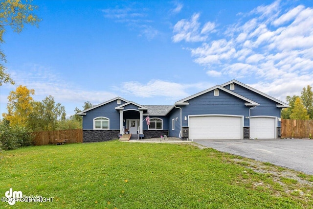 view of front of home with a front yard and a garage