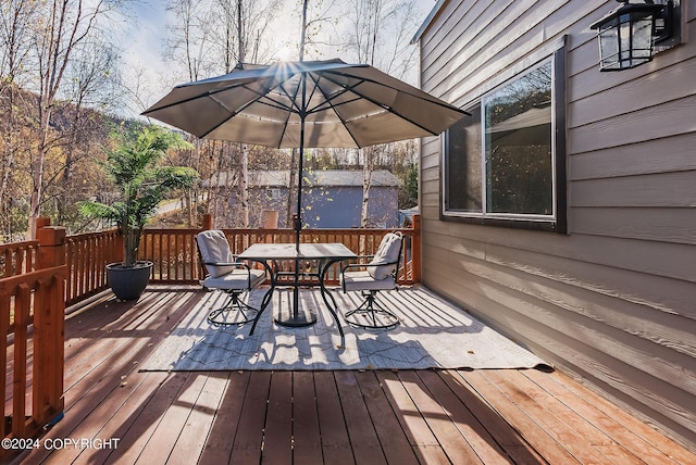 wooden deck featuring outdoor dining area