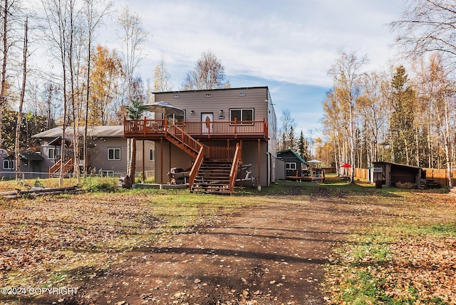 back of house featuring stairway and a deck