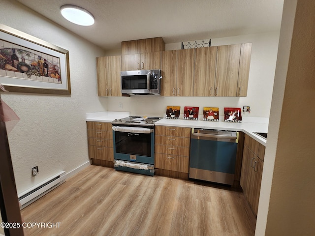 4342 Reka Dr, Anchorage, AK 99508 - kitchen featuring appliances with stainless steel finishes, baseboard heating, light wood finished floors, light countertops, and a textured wall