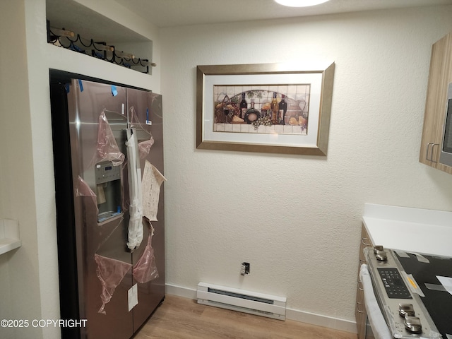 4342 Reka Dr, Anchorage, AK 99508 - laundry room featuring baseboard heating and light wood-style flooring