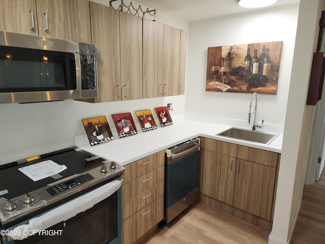 4342 Reka Dr, Anchorage, AK 99508 - kitchen with stainless steel appliances, light wood-style floors, light countertops, and modern cabinets