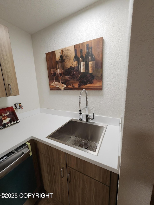 4342 Reka Dr, Anchorage, AK 99508 - kitchen featuring dishwasher, a textured wall, and light countertops