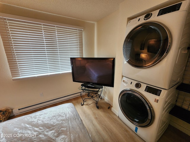 4342 Reka Dr, Anchorage, AK 99508 - washroom with stacked washer / drying machine, wood finished floors, a baseboard radiator, and a textured ceiling