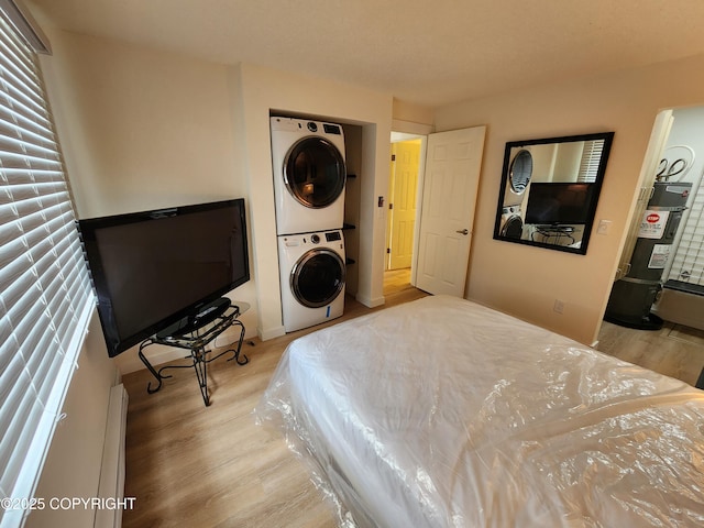 4342 Reka Dr, Anchorage, AK 99508 - bedroom featuring stacked washer and clothes dryer, water heater, and wood finished floors