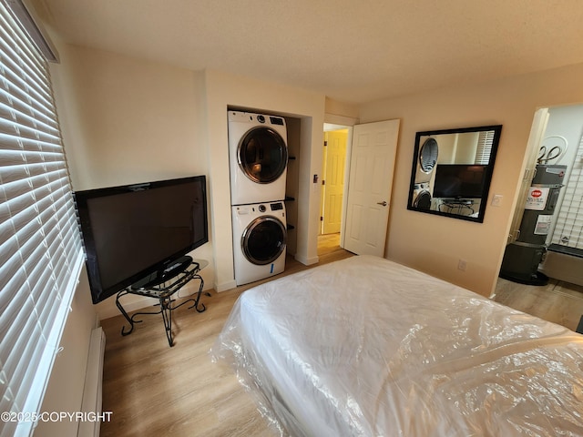 4342 Reka Dr, Anchorage, AK 99508 - bedroom featuring estacked washer and dryer, water heater, and wood finished floors