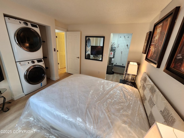 4342 Reka Dr, Anchorage, AK 99508 - bedroom featuring stacked washer / dryer and wood finished floors