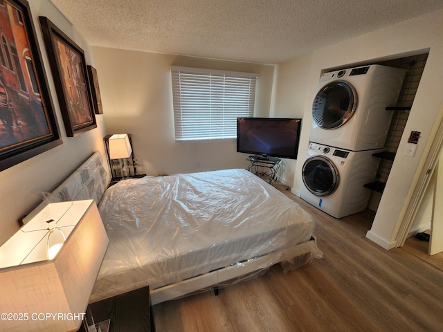 4342 Reka Dr, Anchorage, AK 99508 - bedroom with stacked washer / drying machine, wood finished floors, and a textured ceiling