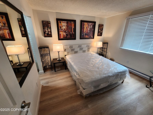 4342 Reka Dr, Anchorage, AK 99508 - bedroom with wood finished floors and a textured ceiling
