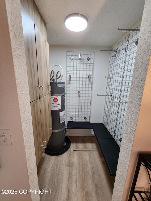 4342 Reka Dr, Anchorage, AK 99508 - interior space featuring wood finished floors, electric water heater, and a textured ceiling
