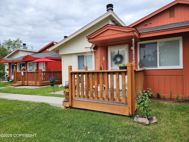 4342 Reka Dr, Anchorage, AK 99508 - wooden deck featuring a lawn