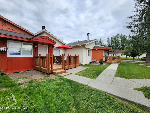 4342 Reka Dr, Anchorage, AK 99508 - rear view of house with a deck and a yard