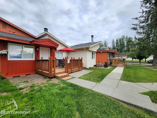 4342 Reka Dr, Anchorage, AK 99508 - back of property featuring a wooden deck and a yard