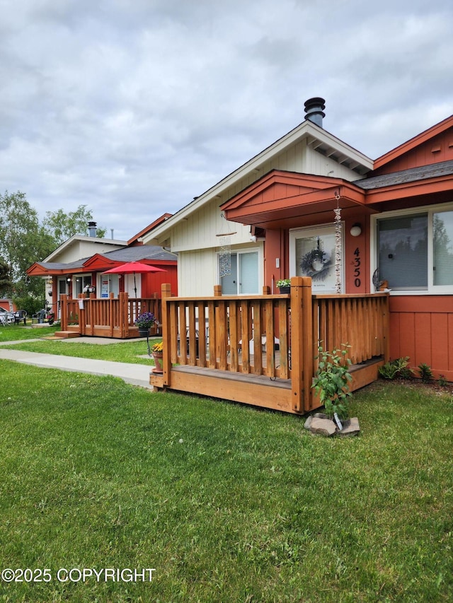 4342 Reka Dr, Anchorage, AK 99508 - back of house with a lawn and a wooden deck