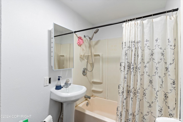 bathroom featuring shower / bathtub combination with curtain and toilet