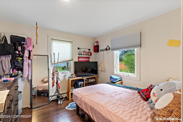 1324 Latouche St, Anchorage, AK 99501 - bedroom featuring multiple windows, dark wood-style floors, and a baseboard heating unit