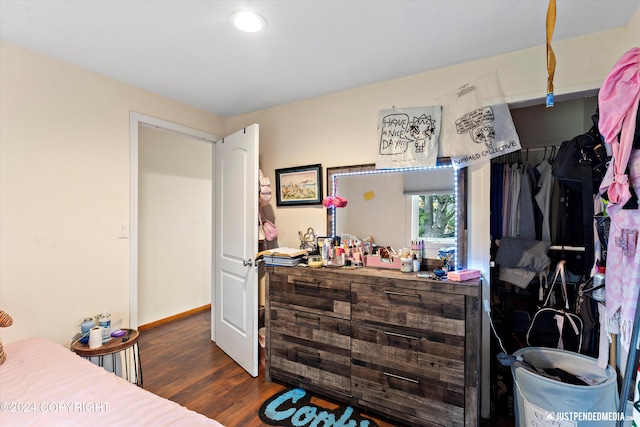 bedroom with dark hardwood / wood-style floors