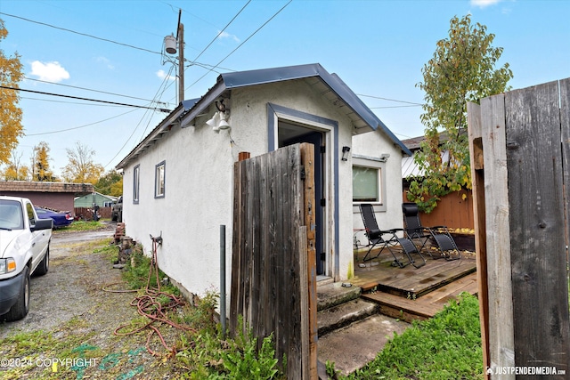1324 Latouche St, Anchorage, AK 99501 - view of property exterior featuring stucco siding and a deck