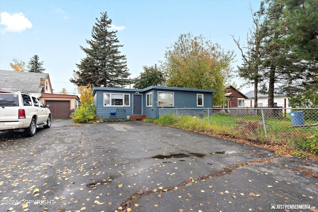 1324 Latouche St, Anchorage, AK 99501 - view of front of house featuring asphalt driveway and an attached garage