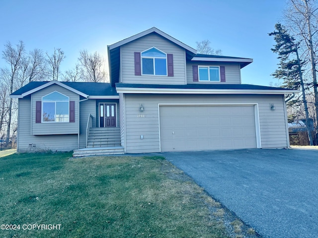 view of front property with a front lawn and a garage